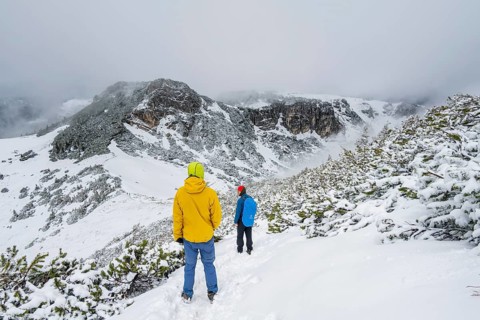 Two hikers on a hiking trail in the snow