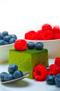 Green tea matcha mousse cake with raspberries and blueberries on top