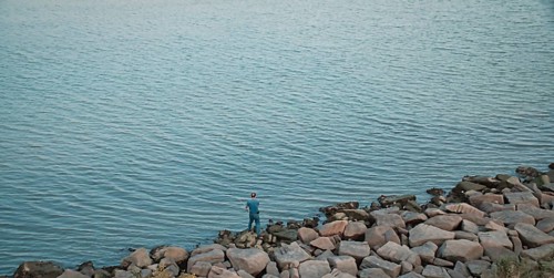 A man fishing by the sea