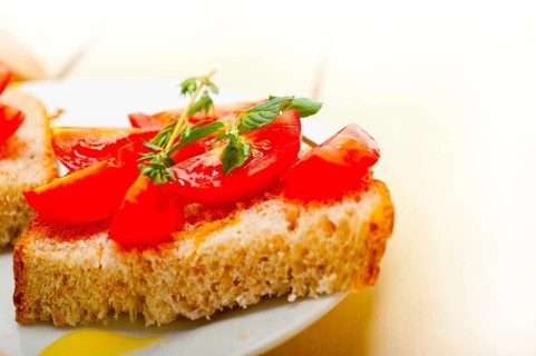 Italian tomato bruschetta with thyme and mint leaves