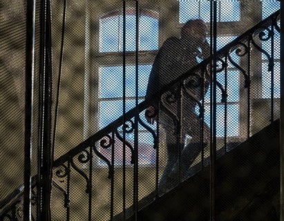View through the bars of an old lift in an old factory
