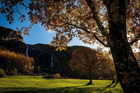 Waterfall in autumn landscape