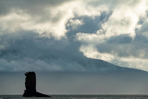 North Atlantic with rock needle and cloudy sky