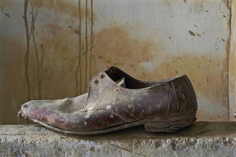 Men's low shoe on wall