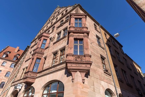 Residential and commercial building with double bay window in neo-Renaissance style