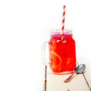 Fresh fruit punch refreshing summer drink over white rustic wood table