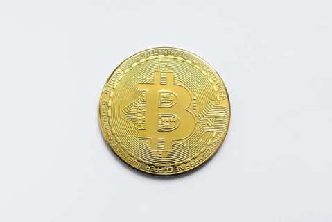 Bitcoin BTC crypto currency gold coins on white background
