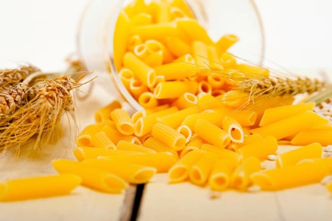 Short Italian pasta penne with durum wheat grains