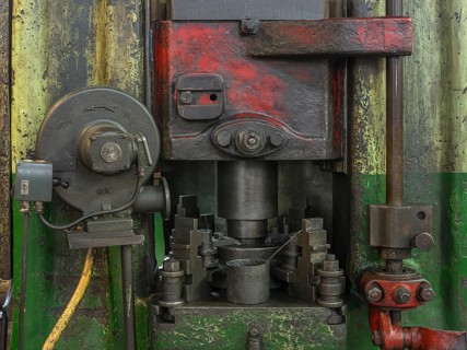 Detail of a screw press in the drop forge in a former valve factory