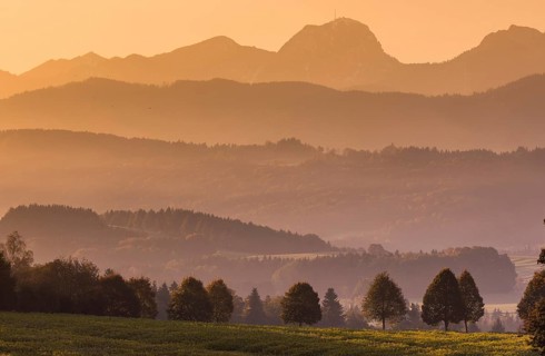Morning mist in the foothills of the Alps at sunrise at the Wilparting pilgrimage church