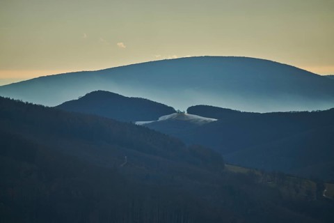 Fog lying in a valley in between to hills