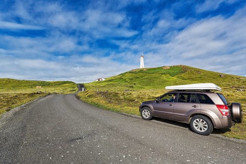 Tourist in an off-road vehicle with roof tent at the roadside