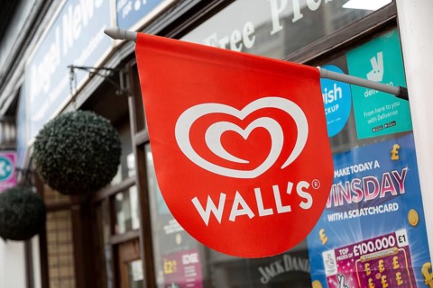 Wall's ice cream red sign outside newsagent shop