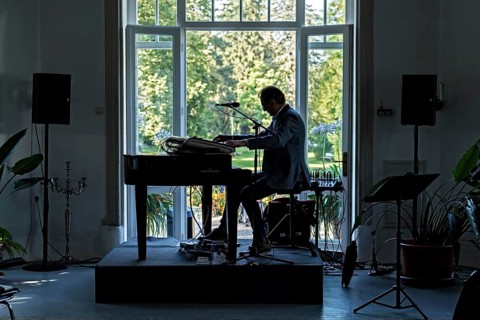 Musician at the piano in the pavilion of the spa hotel