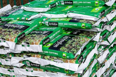 Bags of Levington seed and cutting compost stacked up