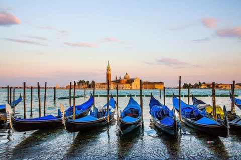 Gondolas in front of the evening panorama of San Giorgio Maggiore