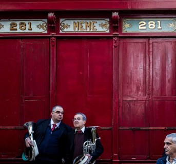 Band club members in front of an old shops facade during the National feast of St. Pauls shipwreck