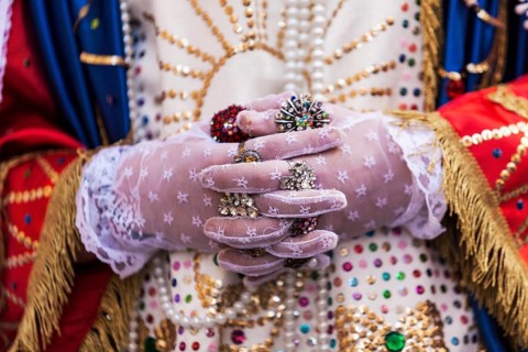 Detail of gloved hands and unique attire of the Veroniche during the Holy Thursday procession in Marsala