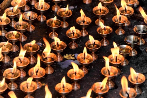 Worshippers light butter lamps