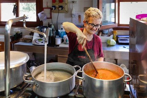 Preparing a lasagne in the kitchen of an agriturismo