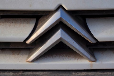Citroeen car logo on dirty radiator grille