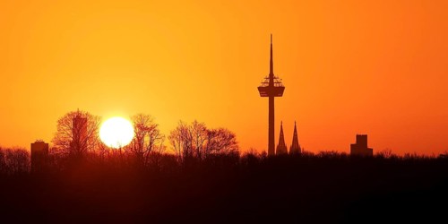 Sunrise over the city skyline with the Colonius telecommunications tower and the cathedral
