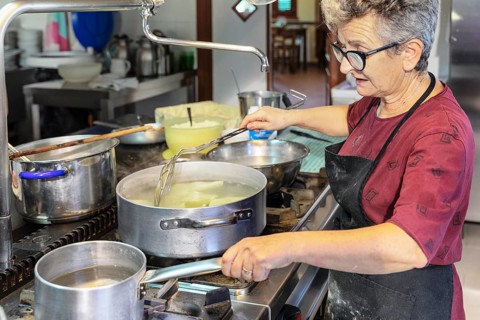 Preparing a lasagne in the kitchen of an agriturismo