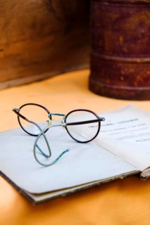 Old glasses on old book for sale at a flea market