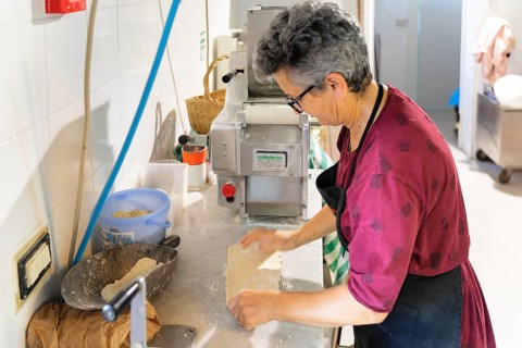 Preparing a lasagne in the kitchen of an agriturismo