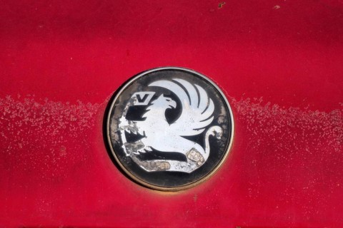 Vauxhall car logo on red paint