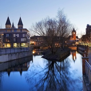 St. Anthony's Parish Church and Old Town Hall Tower with the River Dinkel in the Evening