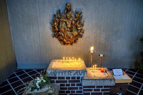 Relief of the Virgin Mary with Christ Child and sacrificial candles