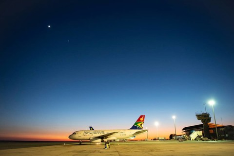 South African Airline on tarmac at sunrise