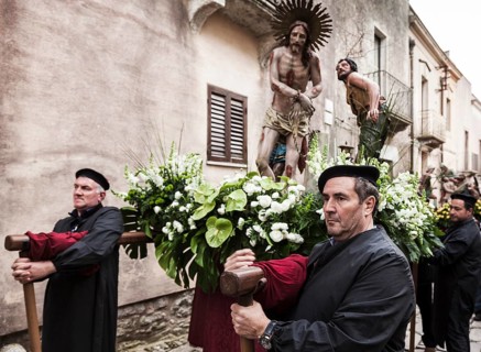Men taking a rest during the Good Friday processions in the streets of Erice