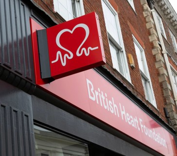 Wall mounted sign outside British Heart Foundation charity shop