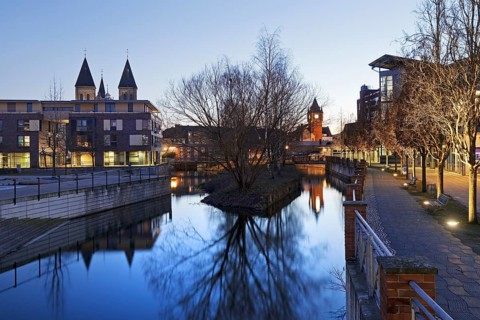 St. Anthony's Parish Church and Old Town Hall Tower with the River Dinkel in the Evening