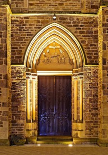 Illuminated entrance to the parish church of St. Suitbertus