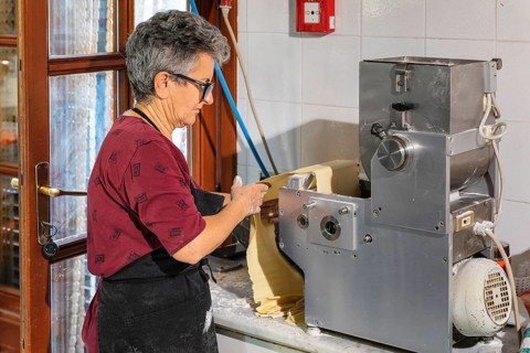 Preparing a lasagne in the kitchen of an agriturismo