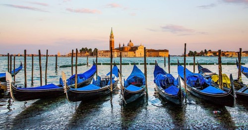 Gondolas in front of the evening panorama of San Giorgio Maggiore