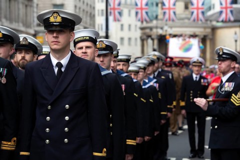 British navy participants enjoy the London Pride festival in brilliant sunshine under Union Jacks. London