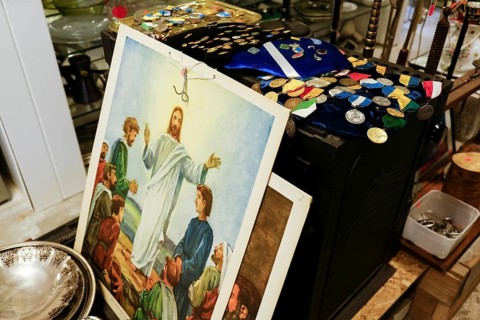 Image of Jesus and various orders for sale at a flea market
