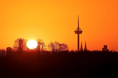 Sunrise over the city skyline with the Colonius telecommunications tower and the cathedral