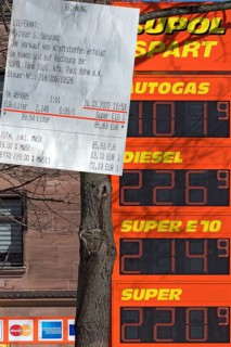 Fuel receipt and electronic price board of a petrol station with over two euros per litre