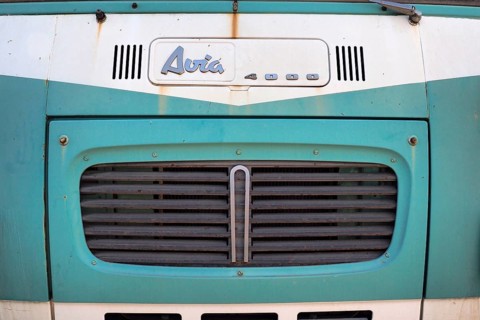 Front view of mint green Avia van