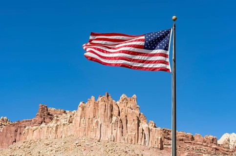 US flag fluttering against a blue sky