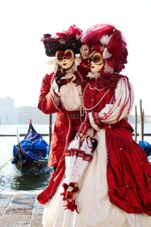 Couple in beautiful costumes on the bacino di San Marco during Venetian Carnival