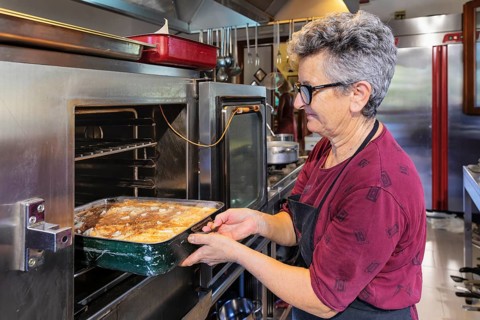 Preparing a lasagne in the kitchen of an agriturismo