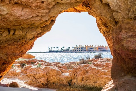 Beautiful sandstone arch with the view from Ferragudo to marina in Portimao