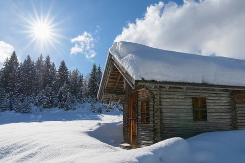 Winter landscape with wooden cabin