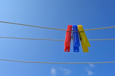 Clothesline with clothespins against blue sky